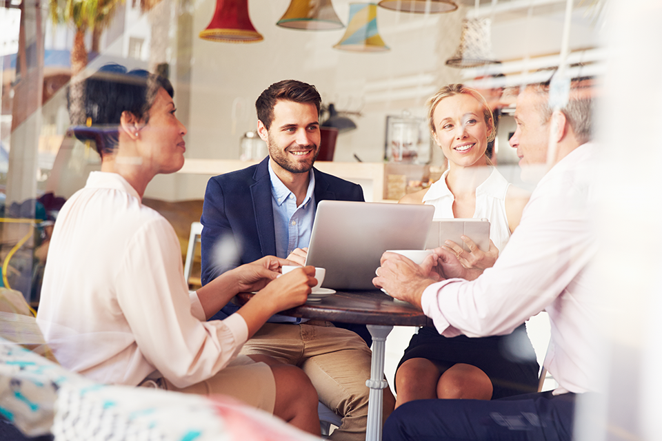 Group of people having a business meeting over coffee