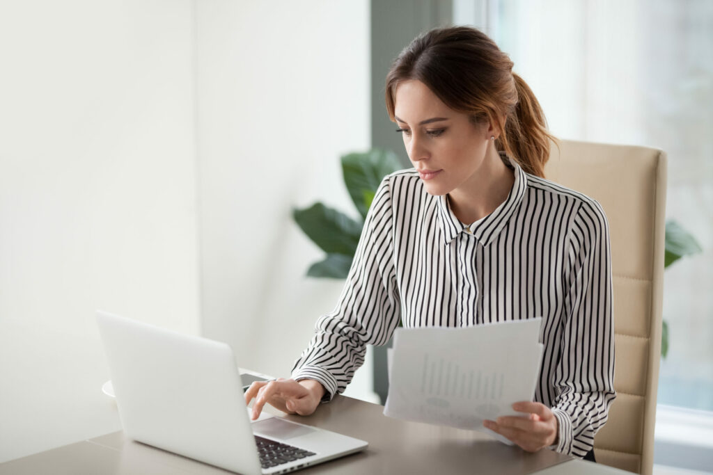 A woman working on a laptop.