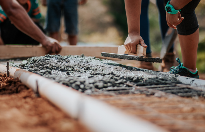 Workers leveling freshly poured concrete